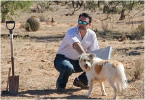 At the UA-Zonge engineering test site in the Sonoran Desert near Tucson, Moe Momayez, associate professor of mining and geological engineering at the UA Lowell Institute for Mineral Resources, prepares to unleash Blue while a Zonge engineer monitors how the dog’s movement shows up on the Helios system. At the UA-Zonge engineering test site in the Sonoran Desert near Tucson, Moe Momayez, associate professor of mining and geological engineering at the UA Lowell Institute for Mineral Resources, prepares to unleash Blue while a Zonge engineer monitors how the dog’s movement shows up on the Helios system.
